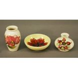 A SMALL GROUP OF MOORCROFT POTTERY comprising two vases and small bowl, tube-lined in various