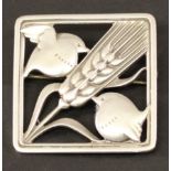 A GEORG JENSEN STERLING (925S) SILVER BROOCH of square form, decorated with two birds feeding on a
