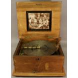 A LATE VICTORIAN INLAID ROSEWOOD POLYPHON DISC PLAYER, the panelled top with foliate inlay lifts