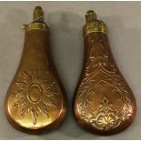 TWO 19TH CENTURY COPPER AND BRASS POWDER FLASKS of traditional form with embossed decoration. 19.5cm