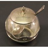 A GEORGE V SILVER AND GLASS PRESERVE POT of globular form, with finial topped cover and waved and