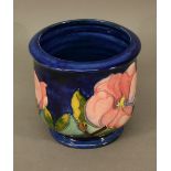 A MOORCROFT 'MAGNOLIA' PATTERN VASE or planter of broad baluster form, tube-lined with flowers