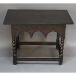 A 17TH CENTURY AND LATER OAK SIDE TABLE having a later planked and cleated top and carved, blind,