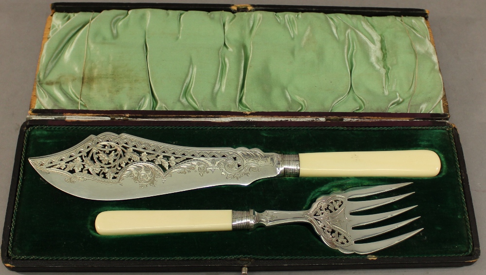 A CASED SET OF SILVER PLATED FISH SERVERS of traditional form with pierced and engraved
