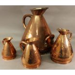 A SET OF FOUR GRADUATING COPPER MEASURES of tapering form with shaped spout and rolled rim, each