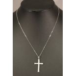A 9K WHITE GOLD DIAMOND SET CROSS PENDANT set with small diamond chips, suspended by a fine-linked