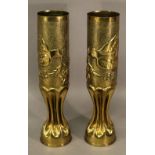 A PAIR OF FIRST WORLD WAR TRENCH ART SHELLS both decorated with birds carrying foliage, dated 1914