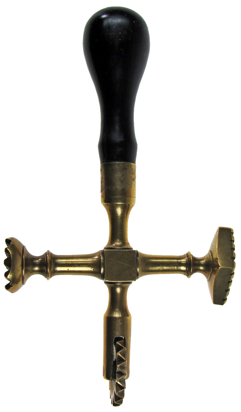 A LATE 18TH/EARLY 19TH CENTURY CRUCIFORM PASTRY JIGGER with brass wheel, lozenge-form and circular