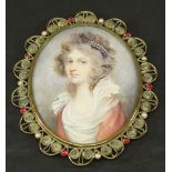 A 19TH CENTURY SCHOOL PORTRAIT MINIATURE of oval form, watercolours on ivory panel depicting a young