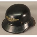 A WW2 ERA LUFTSCHUTZ HELMET painted black with decal to central front, interior lacking liner but