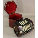 A ROSEWOOD CASED CONCERTINA of typical hexagonal form with fret-cut panels, leather bellows and 46