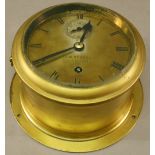 A BRASS CASED BULKHEAD SHIPS CLOCK by J.W Benson (London) of typical form with Roman hours and