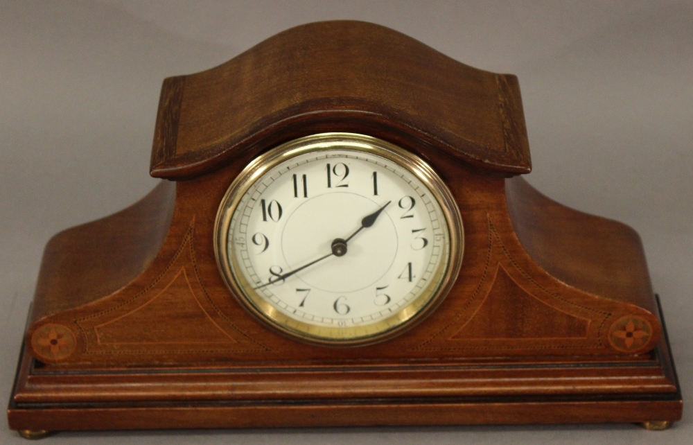 AN EARLY 20TH CENTURY INLAID MAHOGANY MANTEL CLOCK having an arched top, circular dial with Arabic