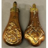 TWO 19TH CENTURY COPPER AND BRASS POWDER FLASKS of typical form, with embossed decoration. 19cm &