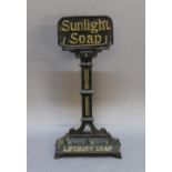 A LATE 19TH CENTURY CAST-IRON 'SUNLIGHT SOAP' STICK STAND, the back moulded 'Sunlight Soap', the