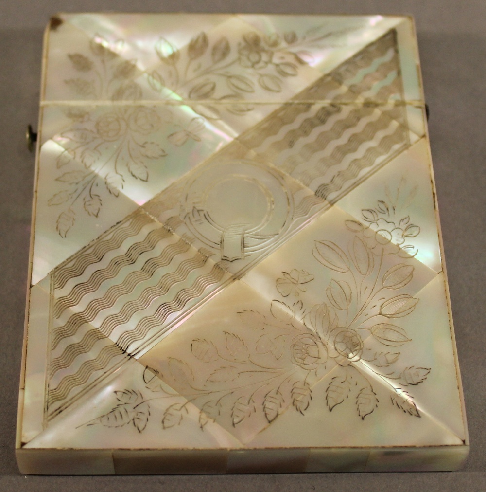 A VICTORIAN MOTHER-OF-PEARL CARD CASE of traditional form with engraved diagonal band and foliate