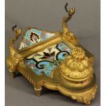 A 19TH CENTURY CONTINENTAL CHAMPLEVE ENAMEL AND GILT METAL INK STAND with enamelled panel and back