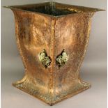 AN ARTS AND CRAFTS COPPER LOG BIN of baluster square section form of riveted construction with
