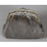 A LATE 19TH CENTURY SILVERY METAL MOUNTED BROWN LEATHER TWO DIVISION PURSE, the shaped mount with