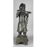 AN 18TH/19TH CENTURY BENIN DARK PATINATED BRONZE FIGURE OF A HORN-BLOWER, probably an altar