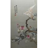 TWO CHINESE SILK EMBROIDERED PICTURES, an eagle perched on a blossoming branch and peacocks in a