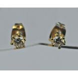 A PAIR OF YELLOW METAL AND DIAMOND SOLITAIRE EARRINGS the brilliant-cut diamonds totalling 0.40cts