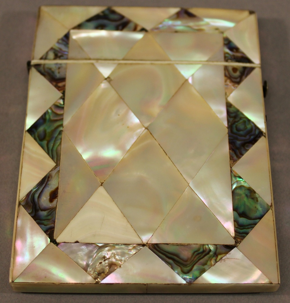 A VICTORIAN MOTHER-OF-PEARL AND ABALONE SHELL CARD CASE of traditional form with geometric abalone