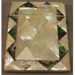 A VICTORIAN MOTHER-OF-PEARL AND ABALONE SHELL CARD CASE of traditional form with geometric abalone