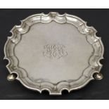 A GEORGE II SILVER WAITER, circular, with moulded arch and crescent border enclosing engraved