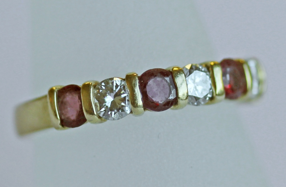 AN 18CT GOLD, DIAMOND AND RUBY HALF ETERNITY RING, a linear arrangement of round-cut rubies