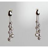 A PAIR OF 18CT WHITE GOLD AND DIAMOND EARRINGS having a two bars with three graduating diamonds (