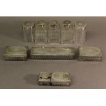 A GROUP OF TEN VICTORIAN SILVER AND CUT-GLASS TRAVELLING ITEMS, comprising two rectangular boxes, an