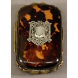 A 19TH CENTURY GILT METAL MOUNTED TORTOISESHELL PURSE of rounded rectangular form with central