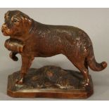 A BLACK FOREST CARVED FIGURE of a St Bernard with spirit casket, inset glass eyes, raised on a