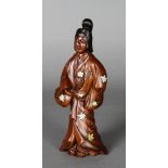 A JAPANESE CARVED WOOD FIGURE OF A STANDING WOMAN, inlaid in ivory and mother of pearl with