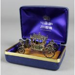 AN ELIZABETH II SILVER MODEL OF THE CORONATION COACH, 7.5cm long, by Toye, Kenning & Spence Ltd.,