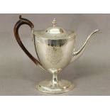 A GEORGE III SILVER COFFEE POT of Neo-Classical shape, with contemporary cartouché, leaf and