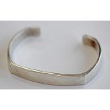 A GEORG JENSEN 925S BANGLE of angled and open circular form, marked 925s Denmark, number 423, by