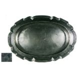 A 19TH-CENTURY CONTINENTAL PEWTER OVAL SERVING DISH with multi-reeded lobed edge, marked on the