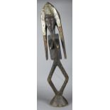 A 20TH CENTURY AFRICAN STAINED SOFTWOOD AND METAL MOUNTED 'KOTA' RELIQUARY of unusual female form.