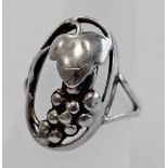 AN 830 GRADE WHITE METAL RING, oval, pierced and moulded with grapes and a vine leaf, marked 830s,