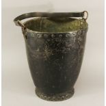 A 19TH CENTURY LEATHER FIRE BUCKET of tapering cylindrical form with studded construction. 30cm(h)
