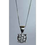 A 9CT WHITE GOLD AND DIAMOND PENDANT inset with seven small diamond brilliants totalling 0.17cts