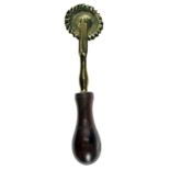 AN EARLY 19TH-CENTURY ENGLISH PASTRY JIGGER of small size, perhaps for a child, with brass wheel and