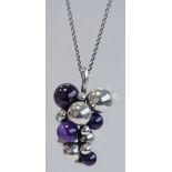 A GEORG JENSEN MIDNIGHT GRAPES PENDANT, a bunch of grapes with four graduating amethysts,