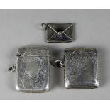 AN EDWARD VII SILVER RECTANGULAR VESTA CASE, engraved with leaf scroll ornament and open shield