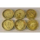 A GROUP OF SIX CAST-BRASS ANIMAL PAW PRINT COASTERS, circular, the bases engraved 'Rowland Ward (c)'