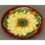 A MOORCROFT POTTERY 'INCA' PATTERN PLATE tube-lined sunflower design, reverse with impressed and