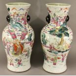 A PAIR OF CHINESE FAMILLE ROSE PORCELAIN CRACKLE WARE VASES with applied handles, each body