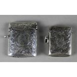 A VICTORIAN SILVER VESTA CASE, with curved edges, engraved with leaf scrolls and circular cartouché,